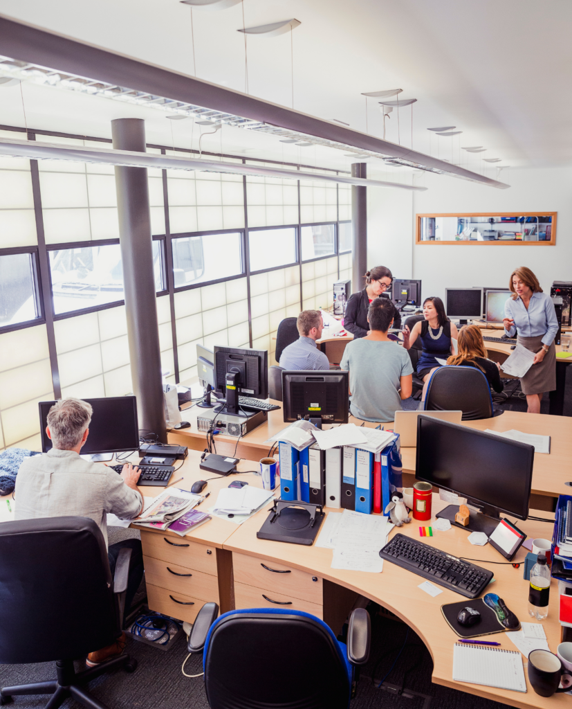 Team of people in office setting discussing sales tactics