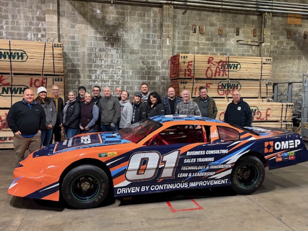 Team photo with the OMEP Pit Crew Race Car Pictured