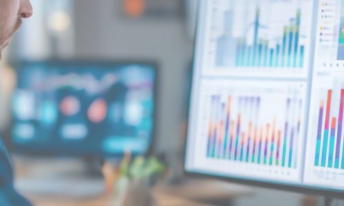 Man looking at computer screen with AI-generated reports